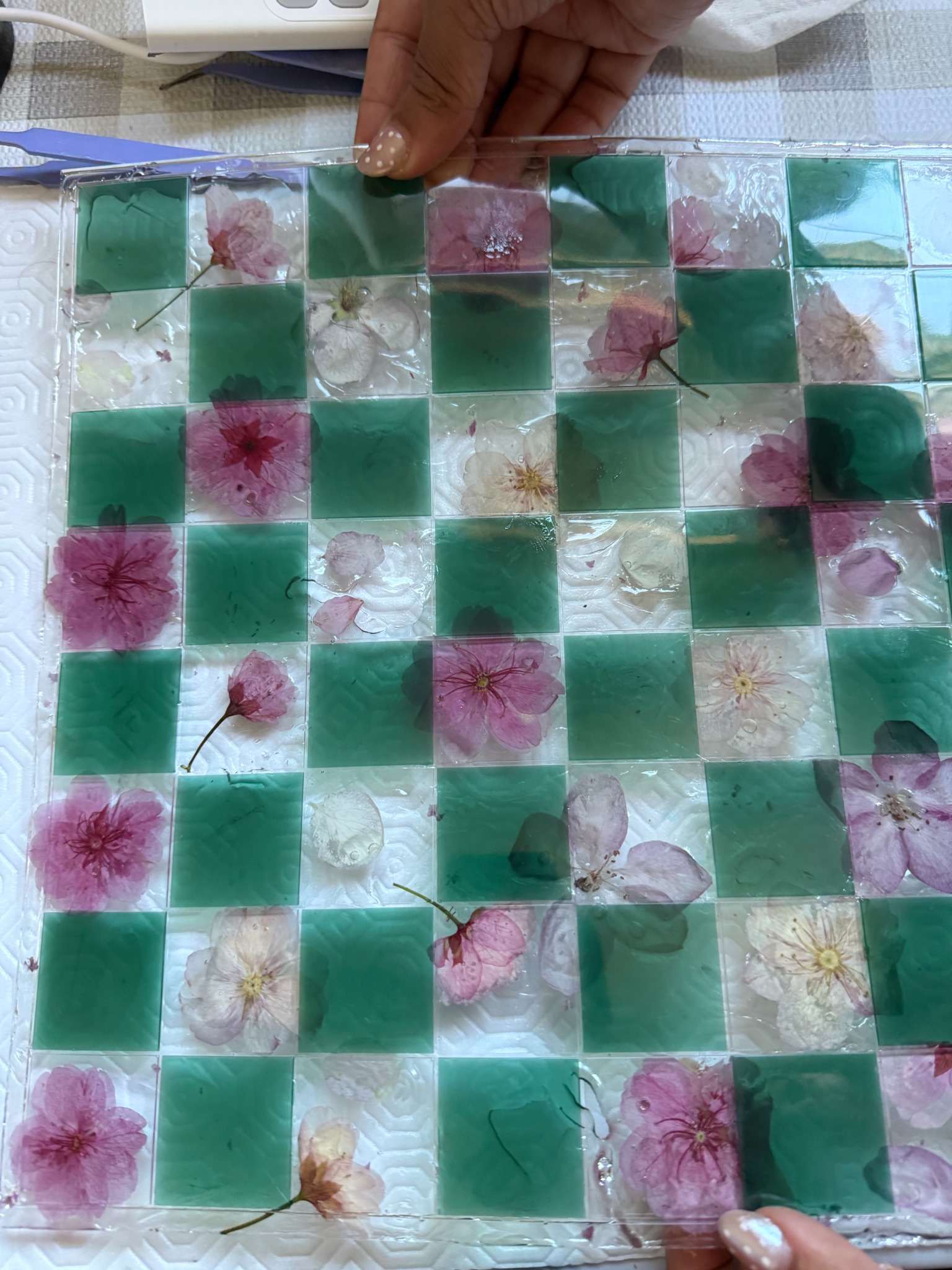 Emerald green floral resin chessboard close-up