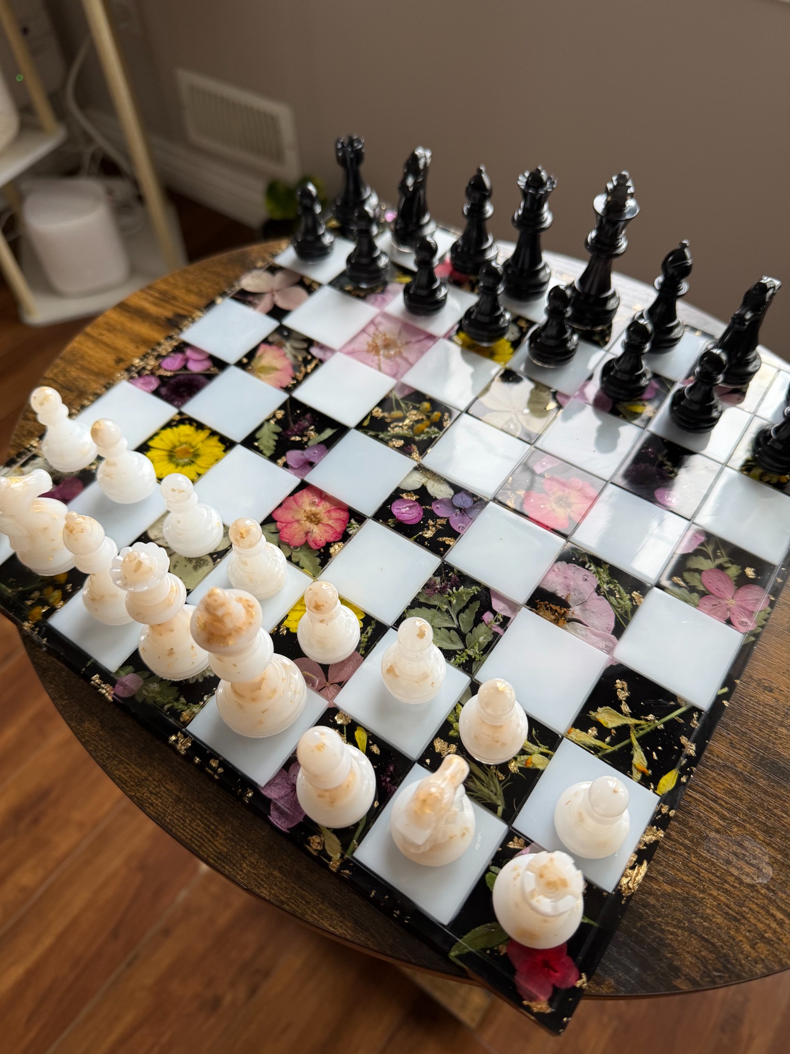 Floral chessboard with black and white resin pieces
