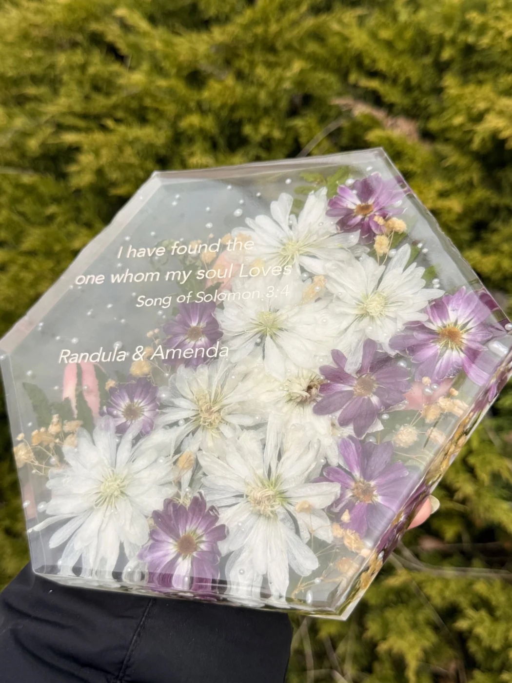 Purple and white flowers preserved in resin